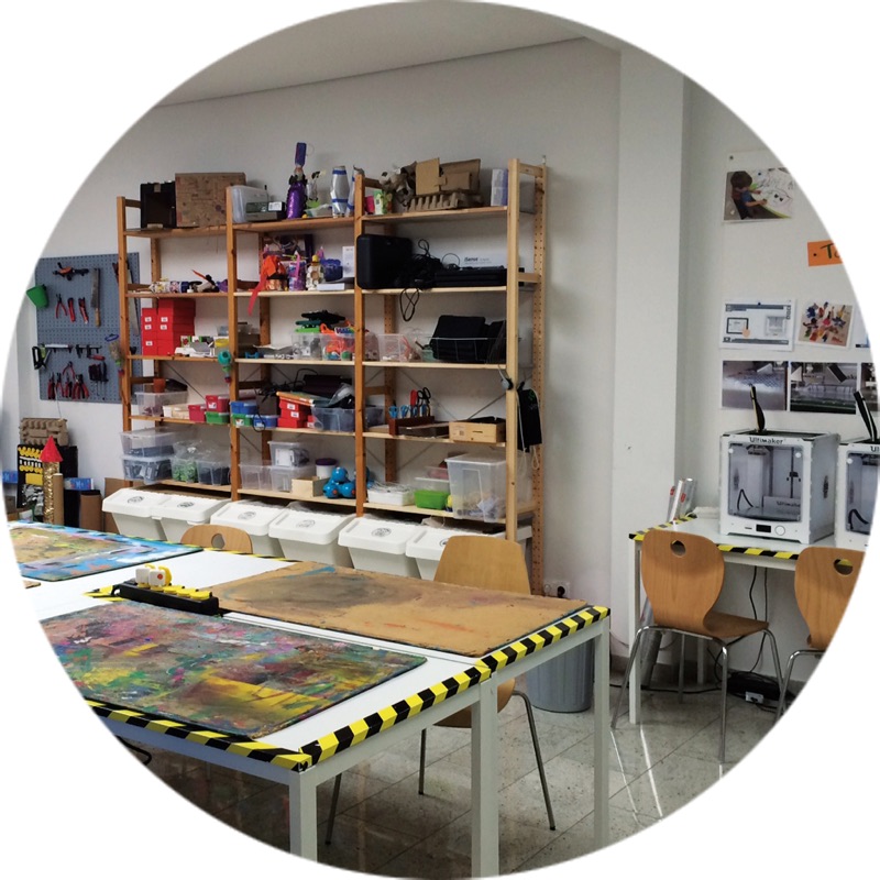 Creative workshop with work tables, tools and 3D printers